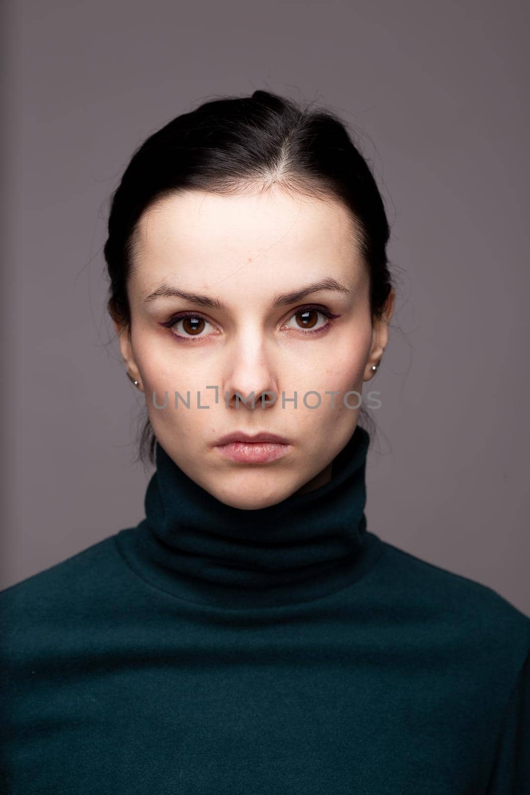 beautiful brunette woman in green turtleneck. High quality photo