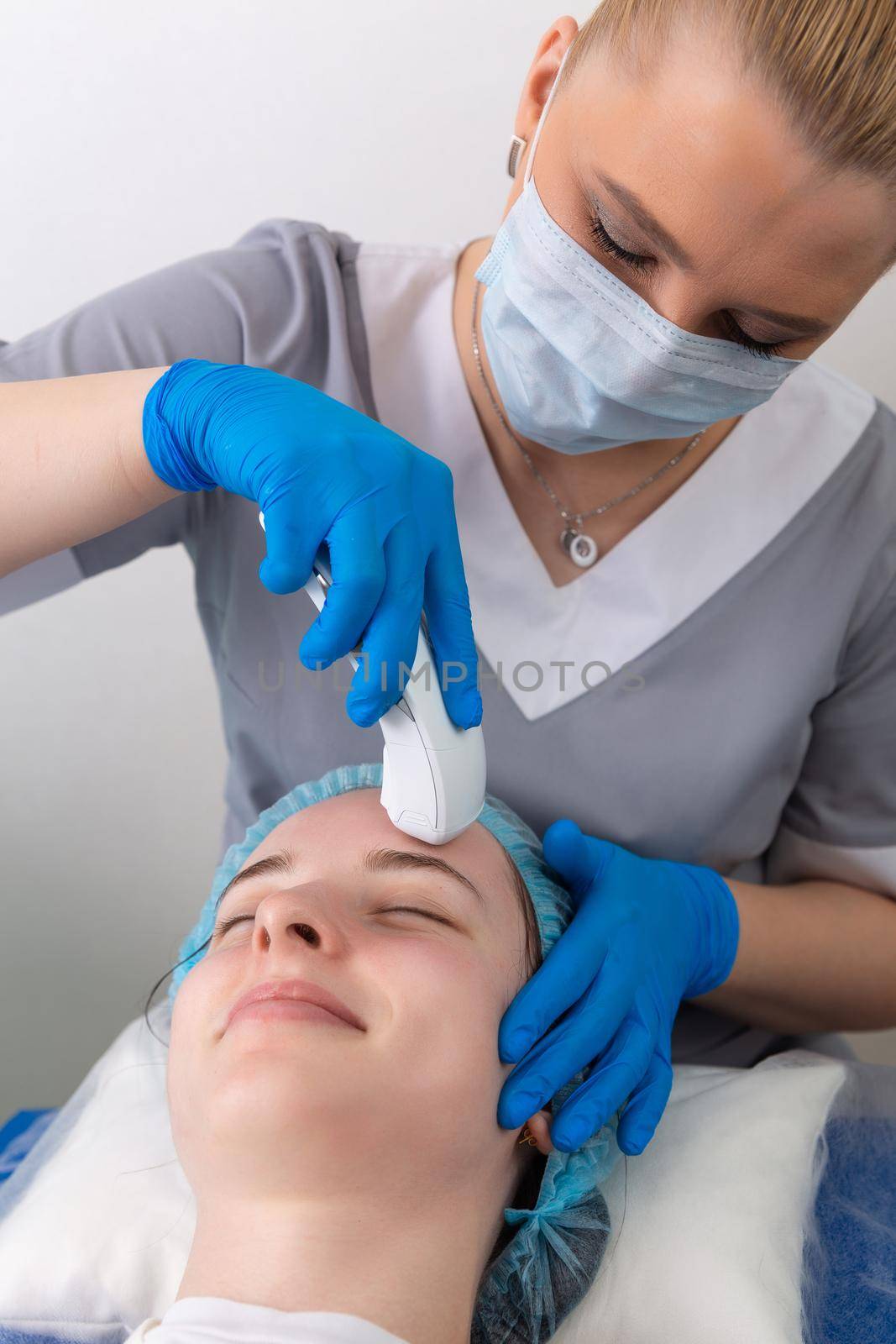 Young woman receiving electric galvanic anti-aging face spa massage at beauty salon. Galvanic massage helps to speed up metabolism, improve regeneration and restore skin protection from harmful external factors.