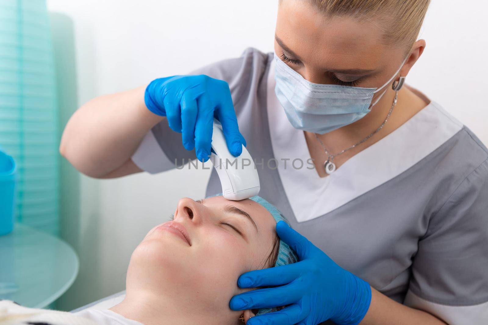 Young woman receiving electric galvanic anti-aging face spa massage at beauty salon. Galvanic massage helps to speed up metabolism, improve regeneration and restore skin protection from harmful external factors.