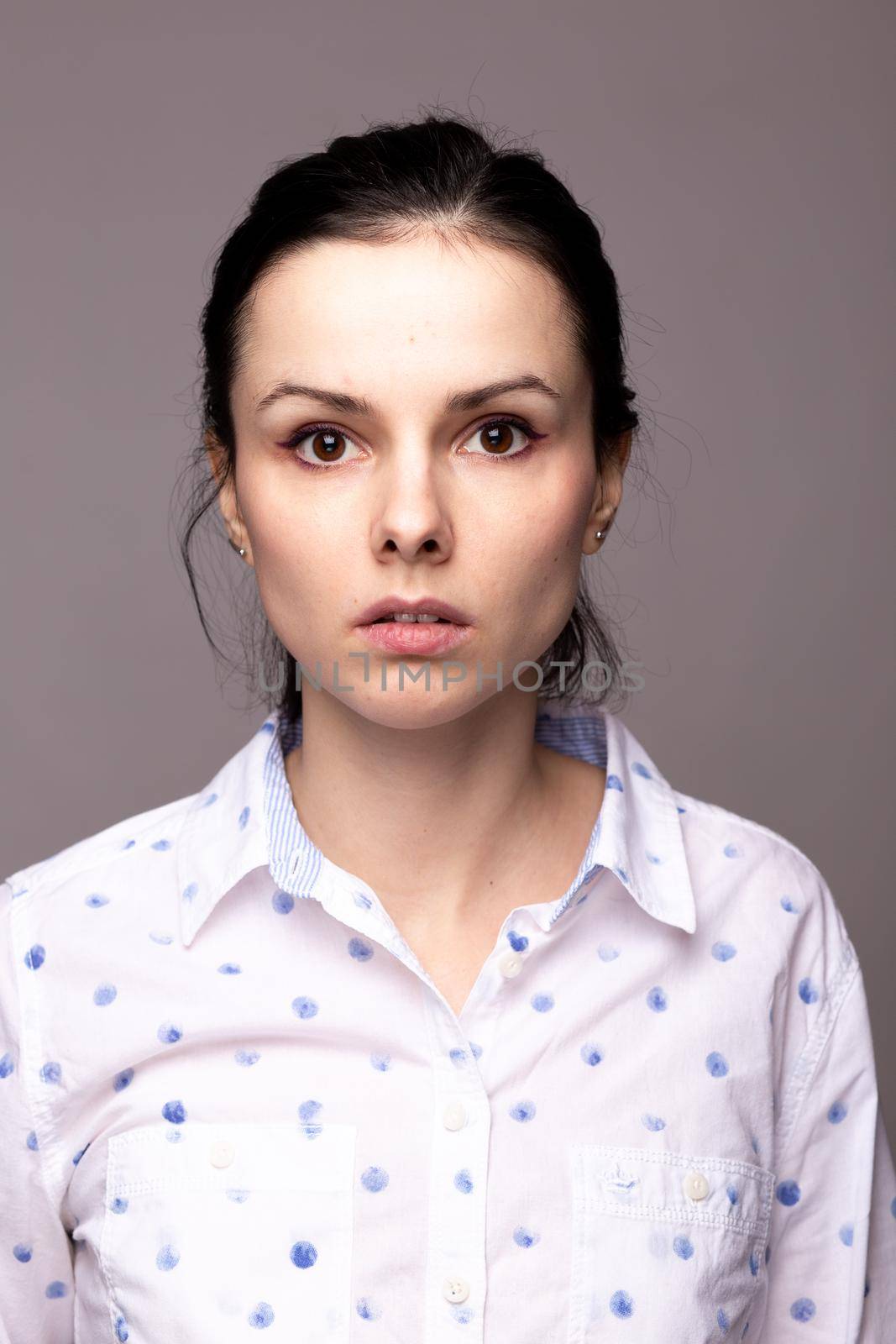 brunette woman in white polka dot shirt. High quality photo