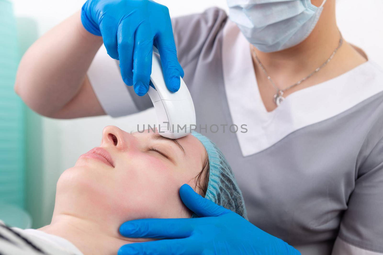 Young woman receiving electric galvanic anti-aging face spa massage at beauty salon. Galvanic massage helps to speed up metabolism, improve regeneration and restore skin protection from harmful external factors.