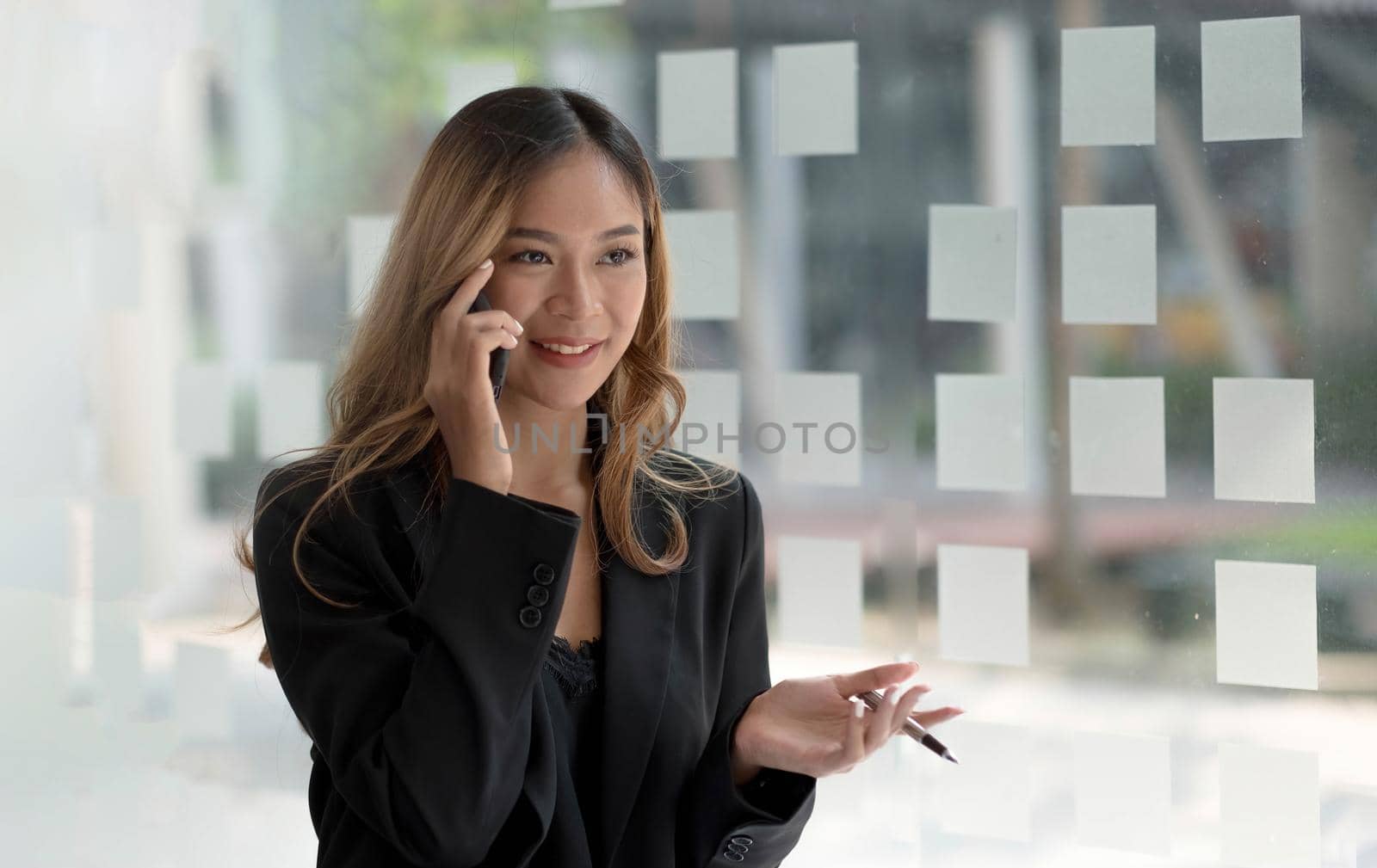 Beautiful asian woman using smartphone, exciting and celebrating with good news of business successful. Small business startup concept. by wichayada
