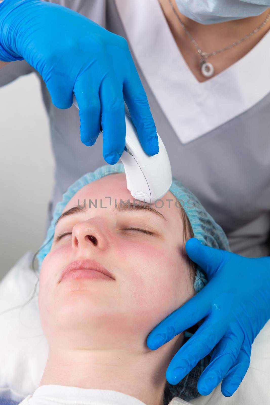 Young woman receiving electric galvanic anti-aging face spa massage at beauty salon. Galvanic massage helps to speed up metabolism, improve regeneration and restore skin protection from harmful external factors.