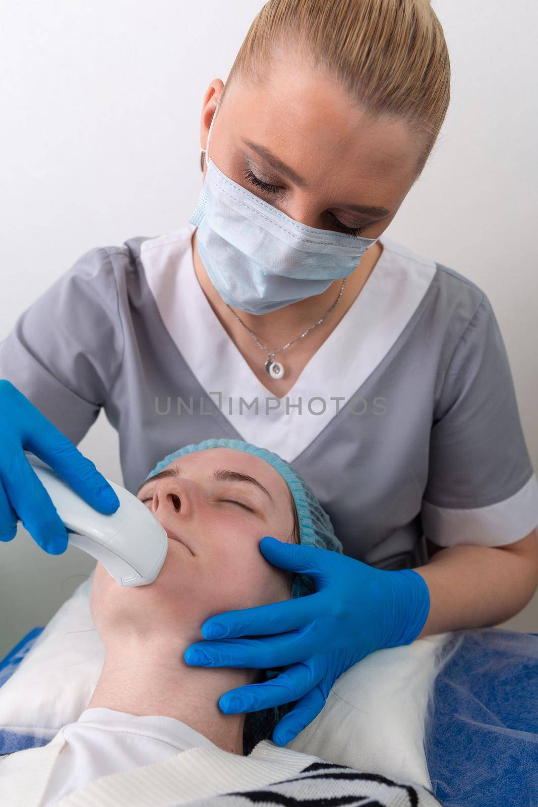 Young woman receiving electric galvanic anti-aging face spa massage at beauty salon. Galvanic massage helps to speed up metabolism, improve regeneration and restore skin protection from harmful external factors.