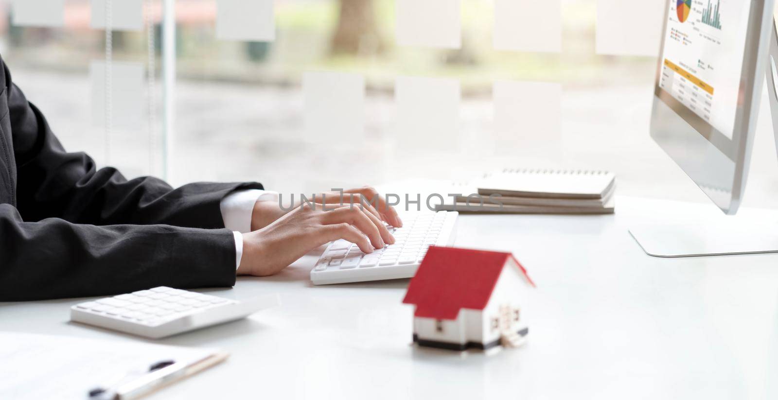 Close up real estate business woman working with pc computer for financial accounting..