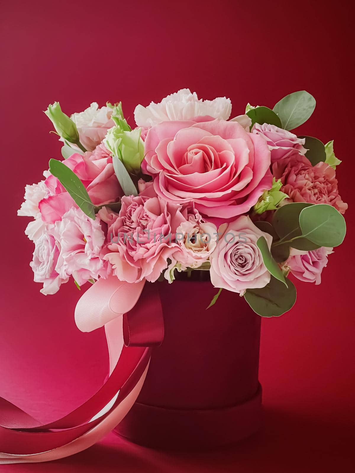 Beautiful flower box on red background, bouquet of blooming flowers as holiday gift, luxury floral design concept