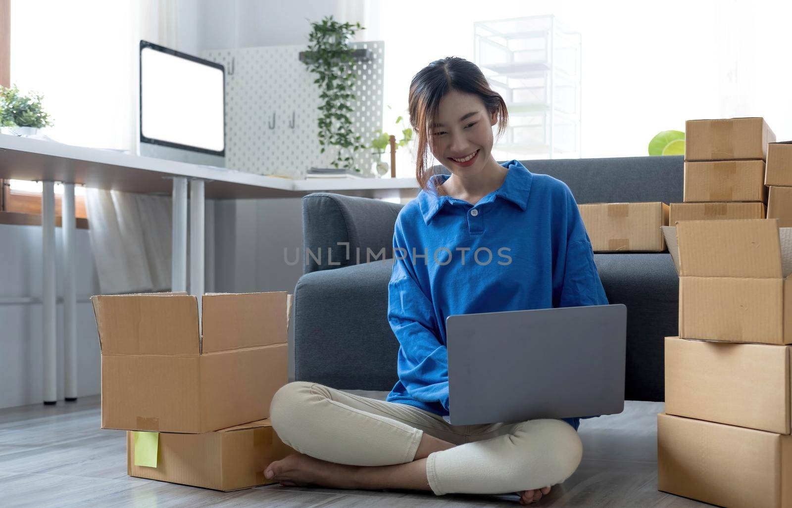 Starting Small business entrepreneur freelance,Portrait young woman working at home office, BOX,smartphone,laptop, online, marketing, packaging, delivery, SME, e-commerce concept.