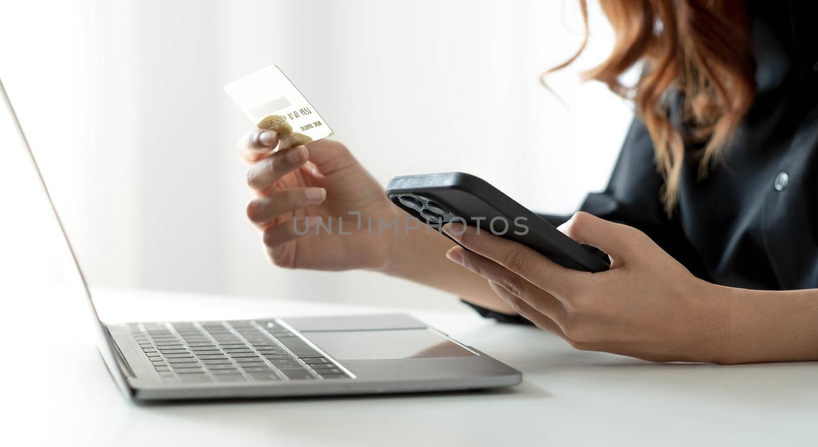 Asian woman checking online order details on smartphone Close control of credit card information entered. by wichayada