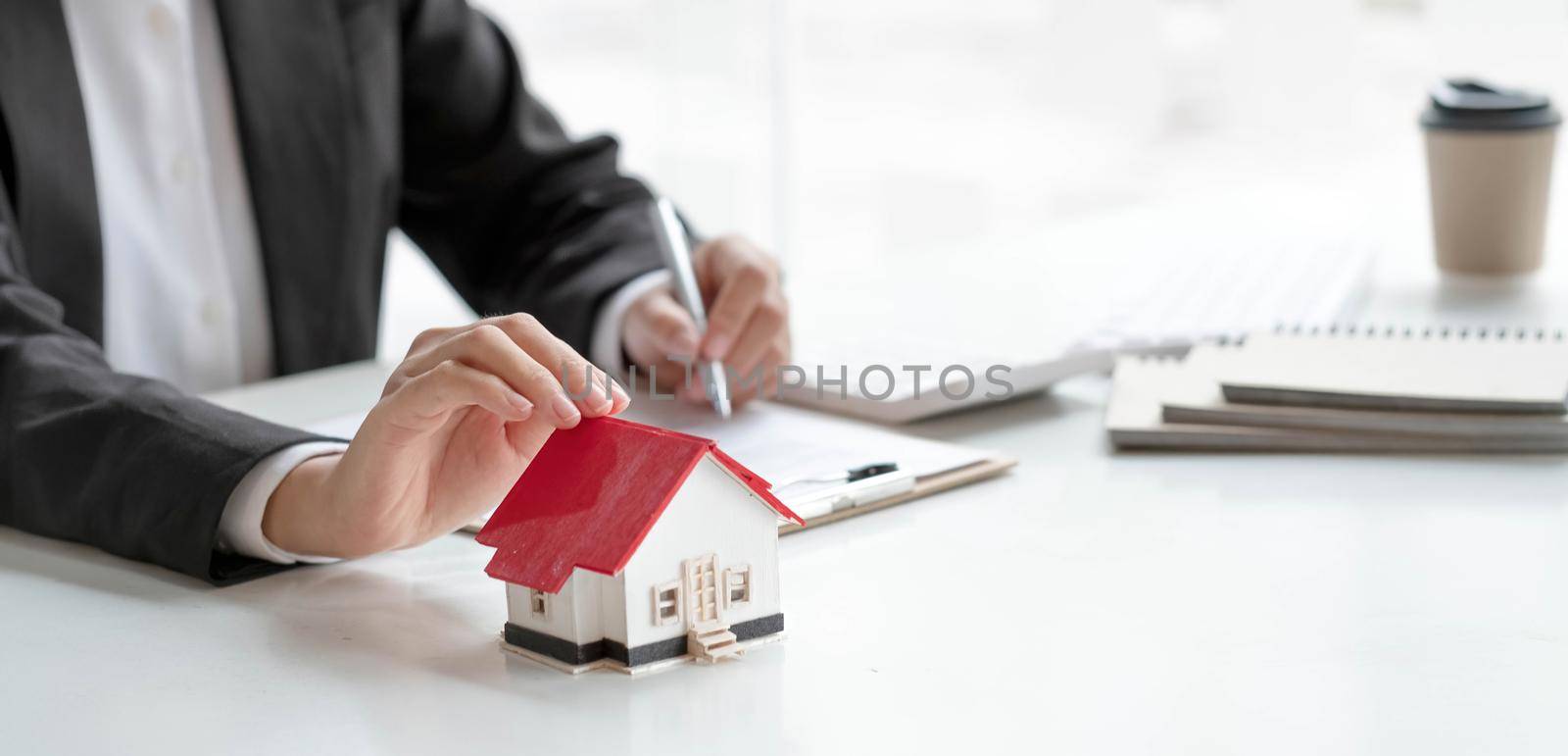 Real estate agent or bank officer describes the loan interest to the customer with home purchase contracts or on office loans and interest rates.