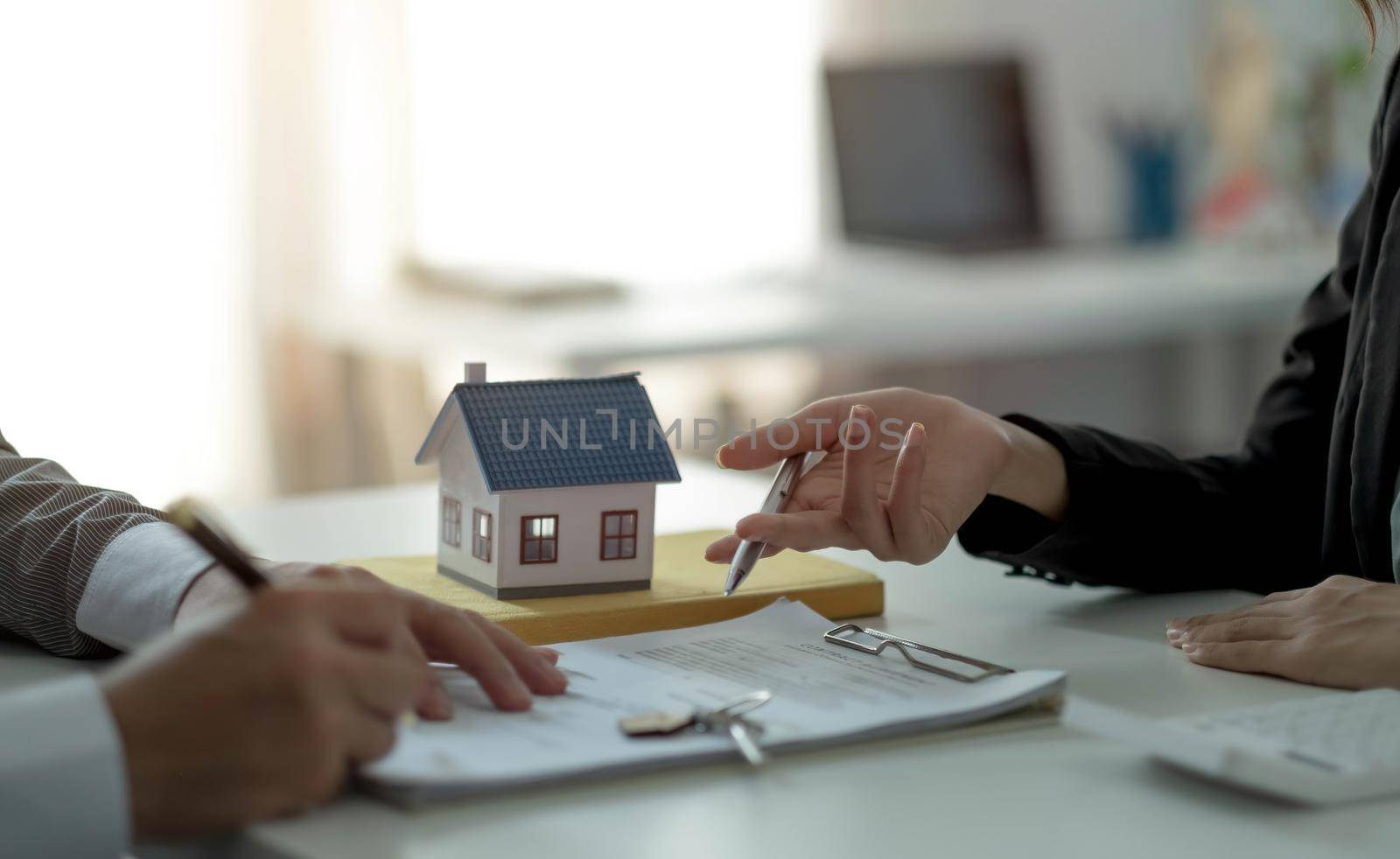 Real estate agent or sales manager has proposed terms and conditions to customers who sign house purchase agreements with insurance, Agreement to sign the purchase contract concept. by wichayada
