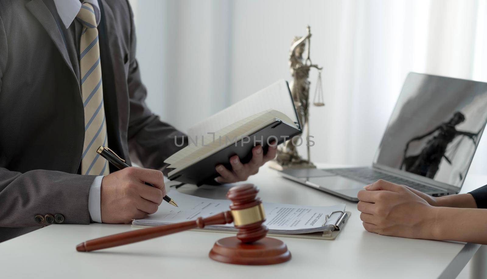 Business woman and lawyers discussing contract papers with brass scale on wooden desk in office. Law, legal services, advice, Justice concept..