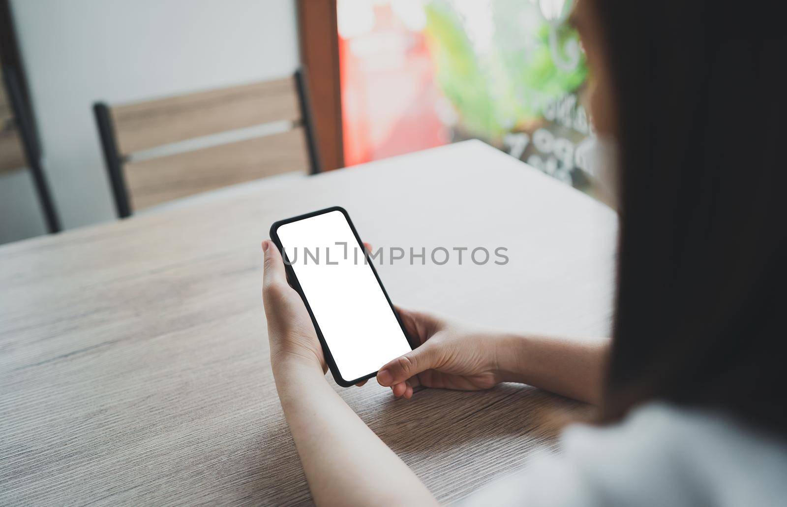 Asian woman hold mobile phone text or message. Businesswoman use modern smartphone to browse web, read e-book, trade stocks. by Wmpix