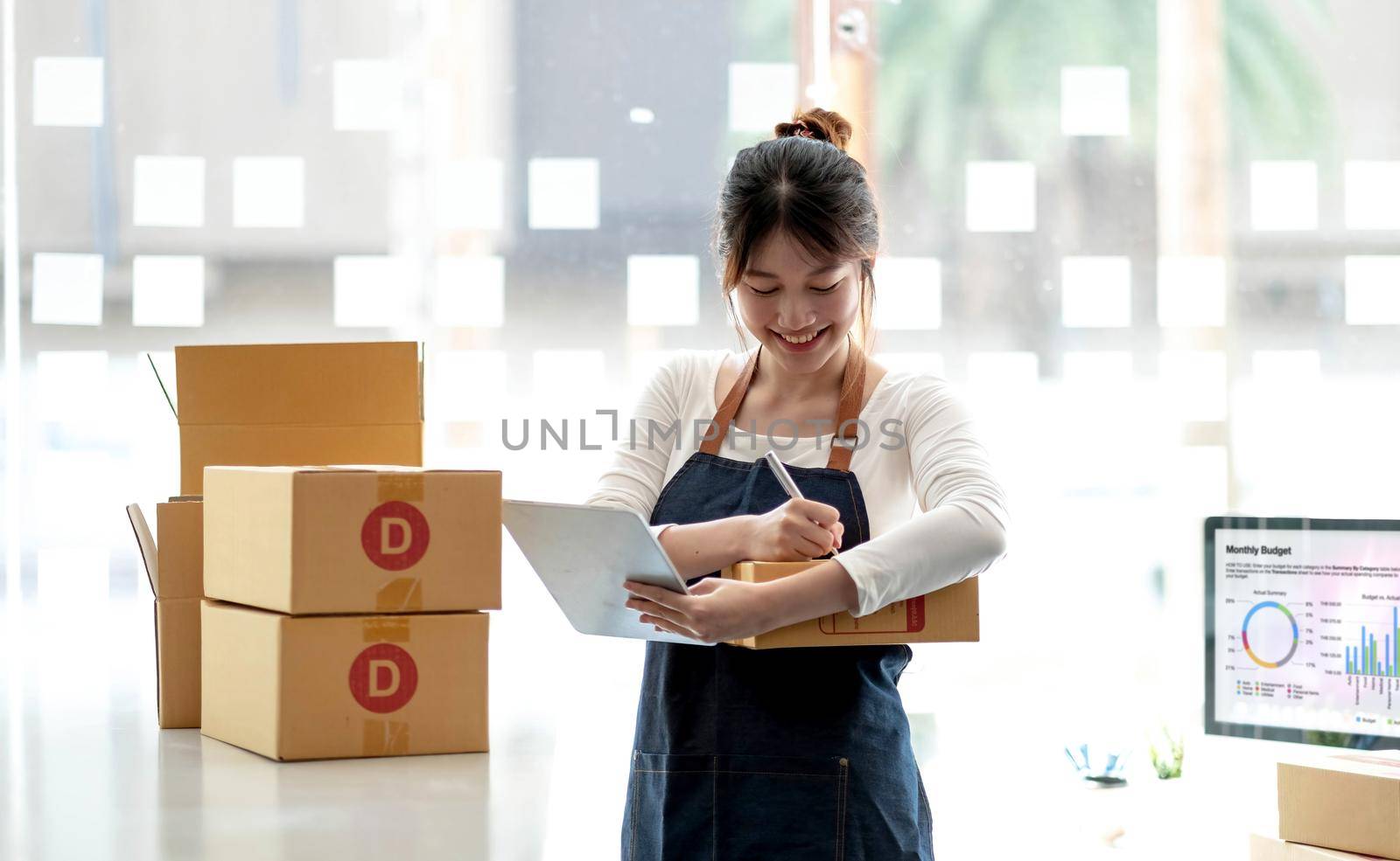 Portrait of Starting small businesses SME owners female entrepreneurs working on receipt box and check online orders to prepare to pack the boxes, sell to customers, sme business ideas online..