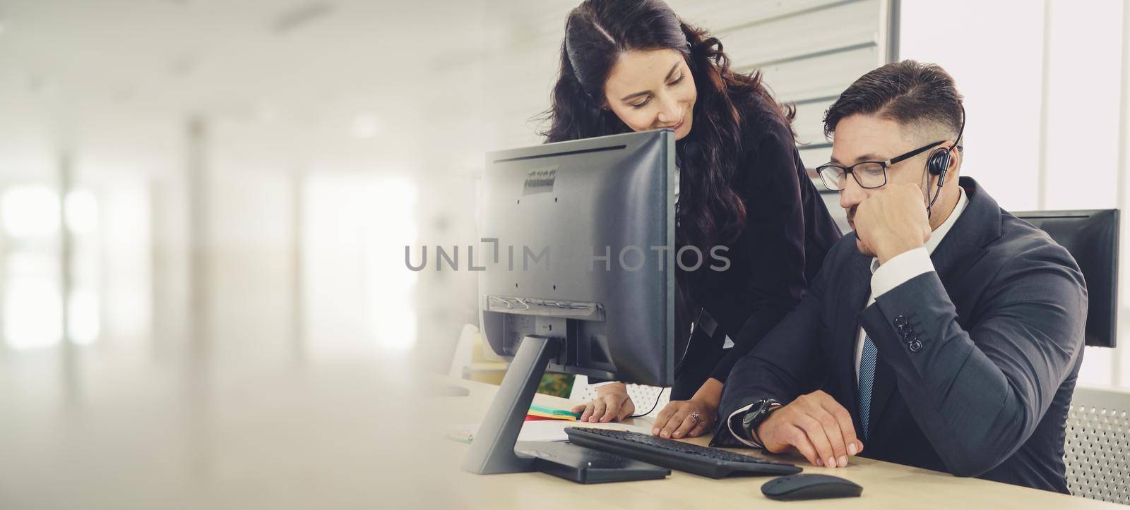 Business people wearing headset working in office to support remote customer or colleague. Call center, telemarketing, customer support agent provide service in broaden view .