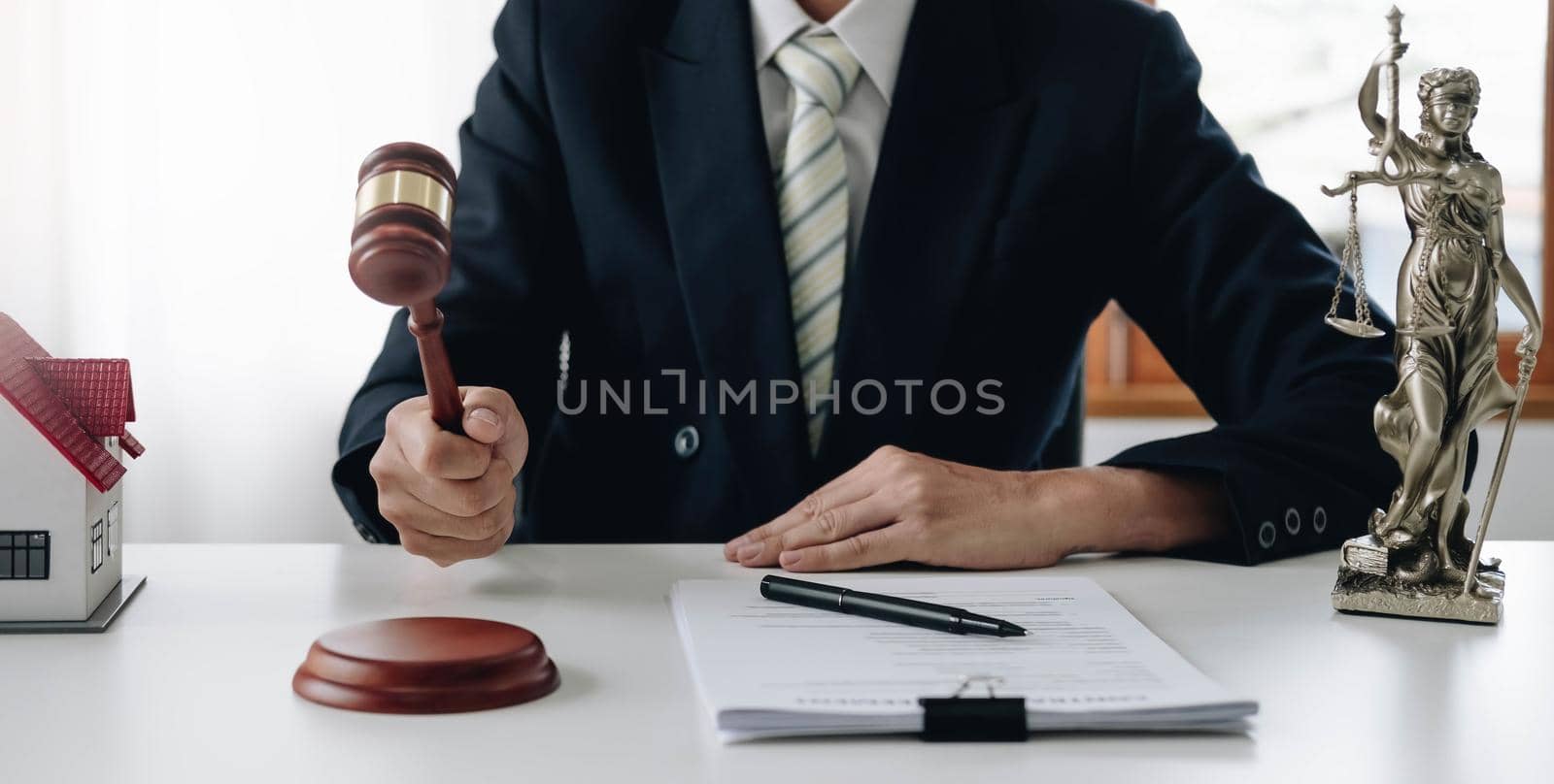 Lawyer or judge holding Hammer prepares to judge the case with justice, and litigation, scales of justice, law hammer, Legal consulting services, Concept of litigation, and legal services..