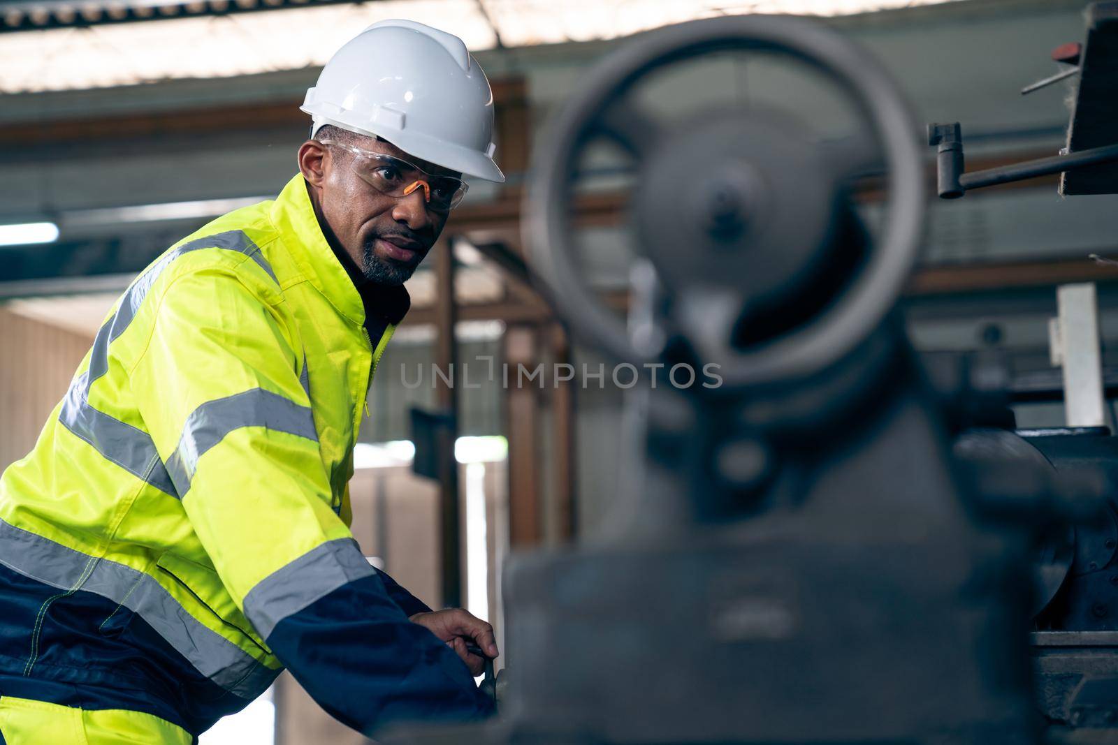 Factory worker or engineer do machine job in adept manufacturing workshop . Industrial people and manufacturing labor concept .