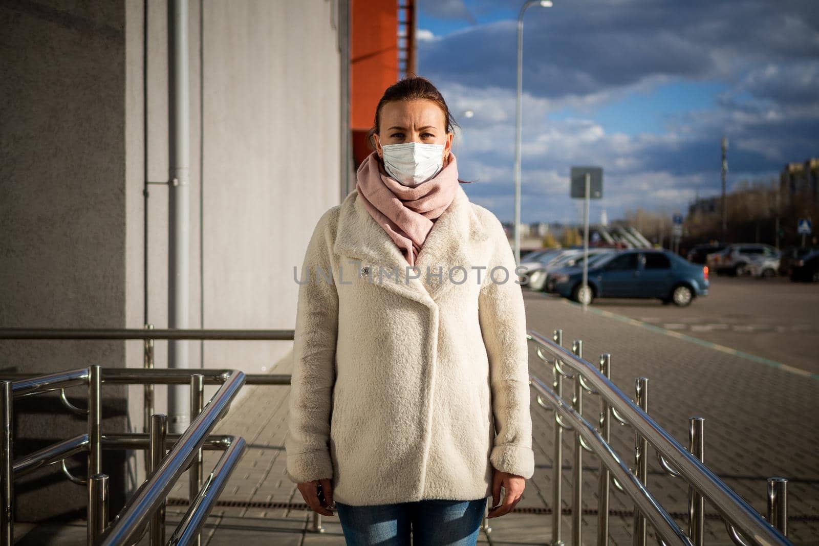 A picture of a girl in a mask. On the street. isolated Covid-19 pandemic.