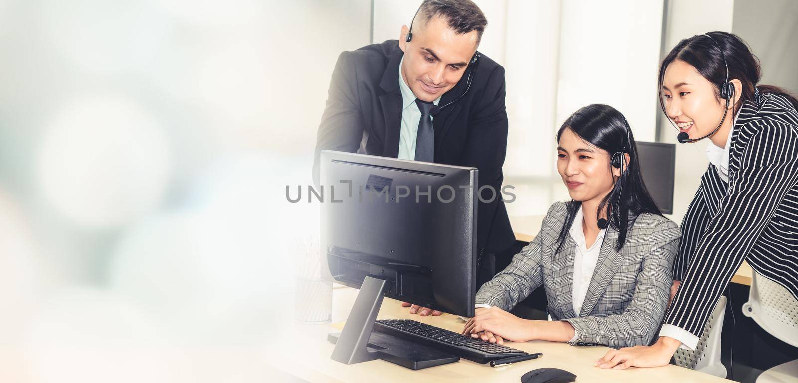 Business people wearing headset working in office broaden view by biancoblue