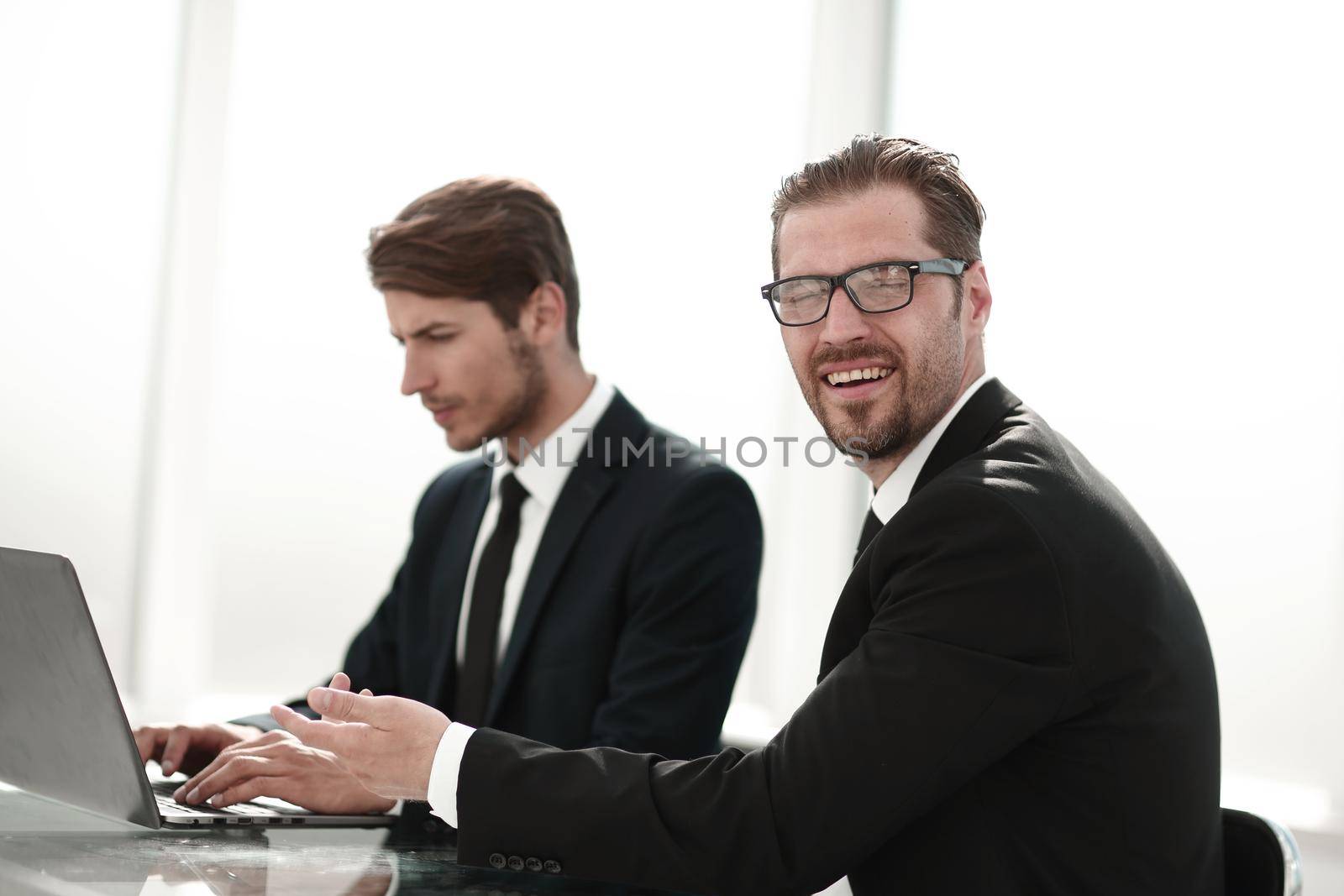 two business people sitting at the Desk by asdf