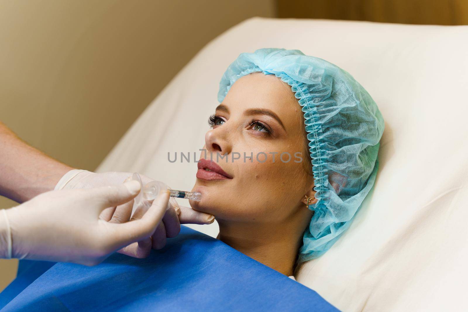 Filler injection of hyaluronic acid. Contour plastic for correcting the volume and shape of the nose, chin, cheekbones, temples.