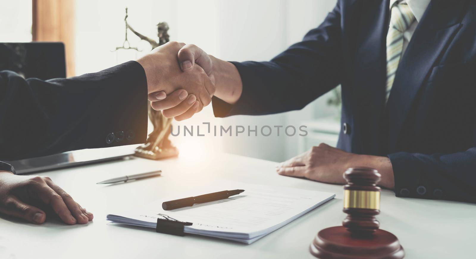 Handshake after good cooperation, Consultation between a male lawyer and businessman customer, tax and the company of real estate concept. by wichayada