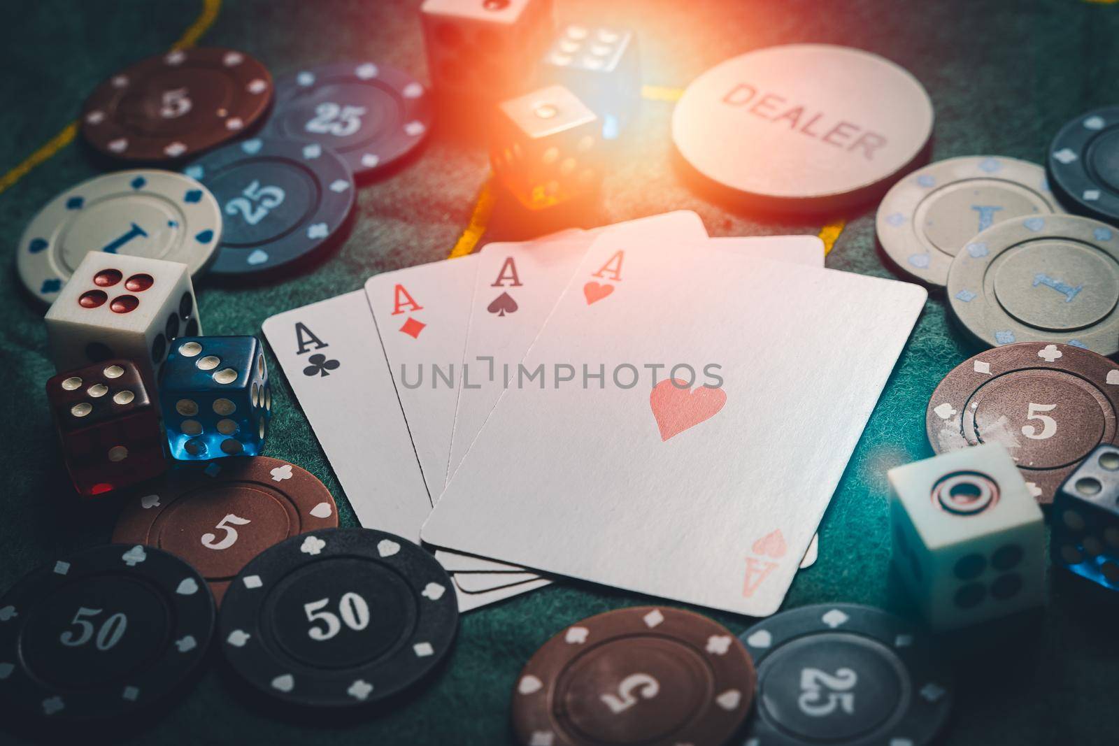 close-up playing chips and playing cards. casino poker game concept. Playing cards, poker chips, and dices on green table. the view from the top by Wmpix