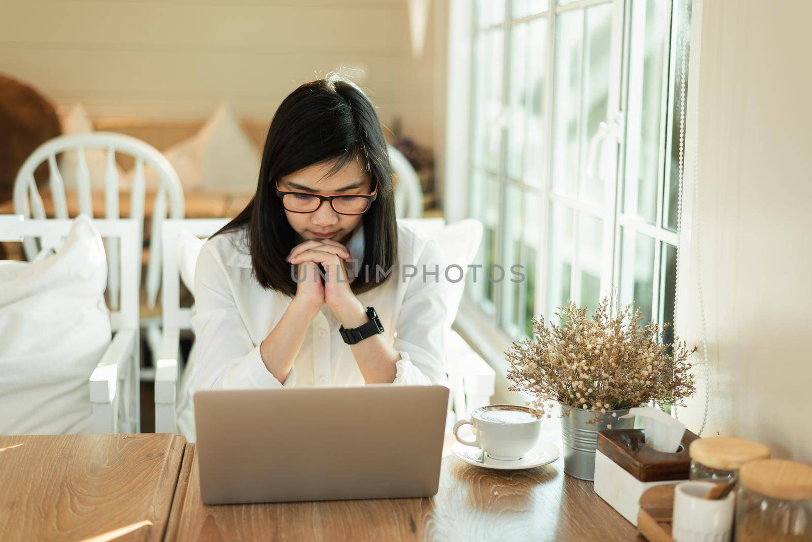 Business asian woman feel tired and serious and working with laptop. Depression asian woman working hard. by Wmpix
