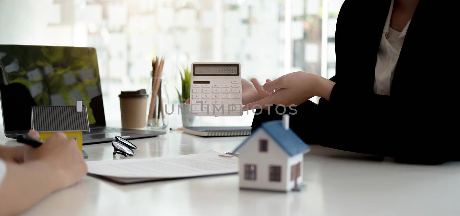 Real Estate Agent broker or House developer showing contract for buying house agreement to consultant employee.