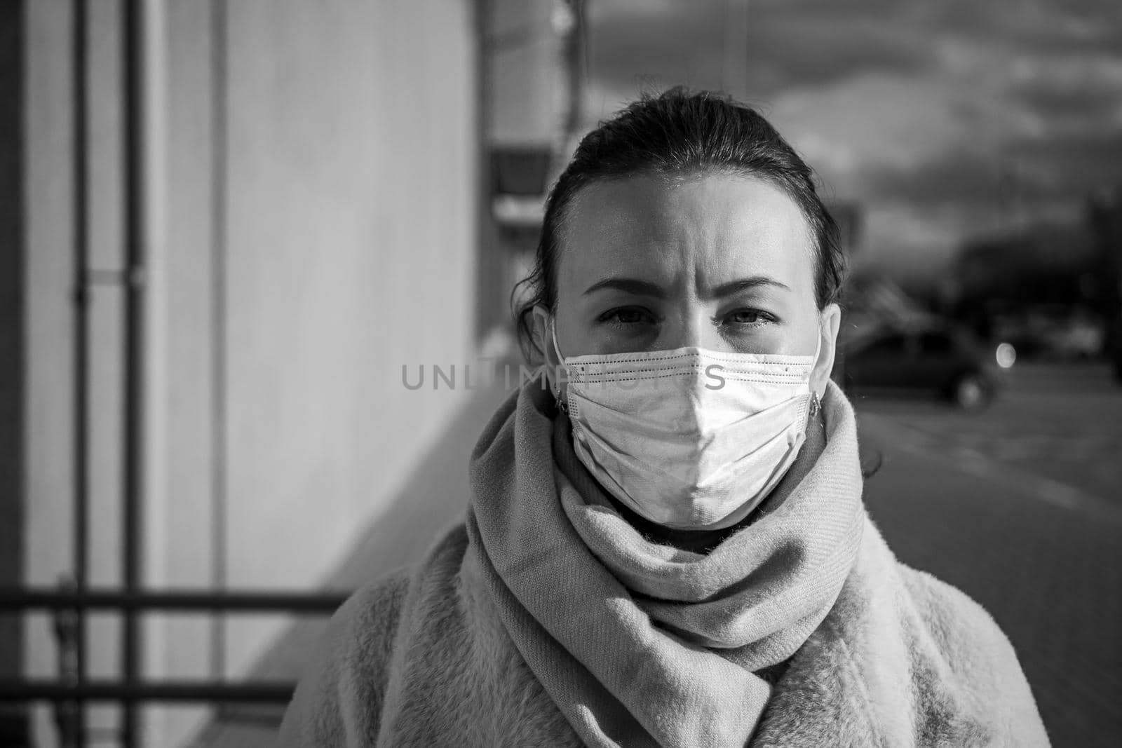 A picture of a girl in a mask. On the street. isolated Covid-19 pandemic.