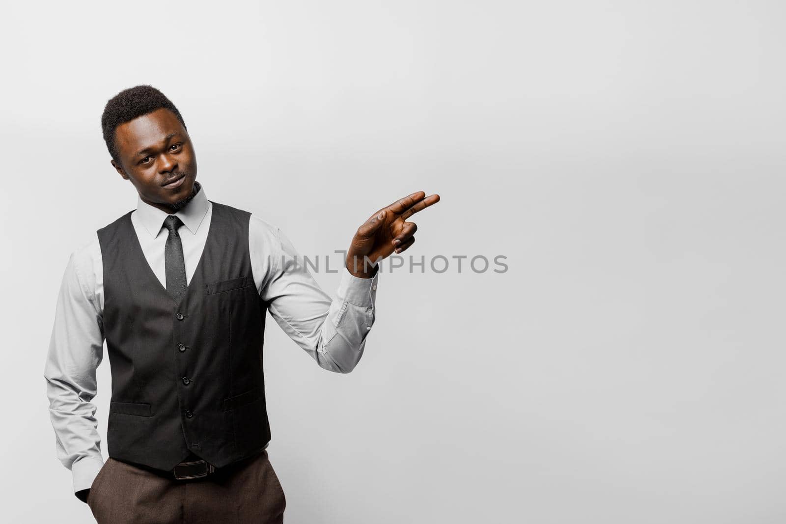 Black african business man points to right side empty for adver text. You can change your life. Successful people lifestyle advert.