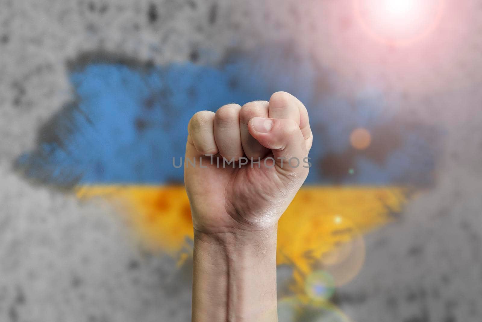 Support for Ukraine and solidarity. Help to the Ukrainian people in wartime. Fists as a symbol of support against the background of the Ukrainian flag. The concept of confrontation and struggle by SERSOL