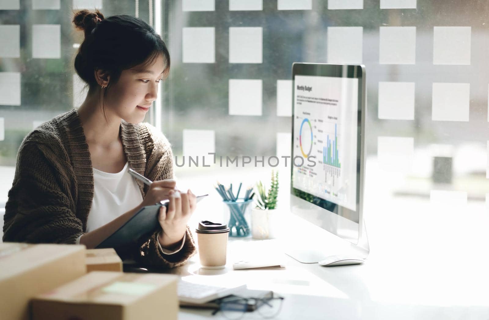 Cheerful asian woman working in office use computer with copy space. Business owner people sme freelance online marketing e-commerce telemarketing, work from home concept by wichayada