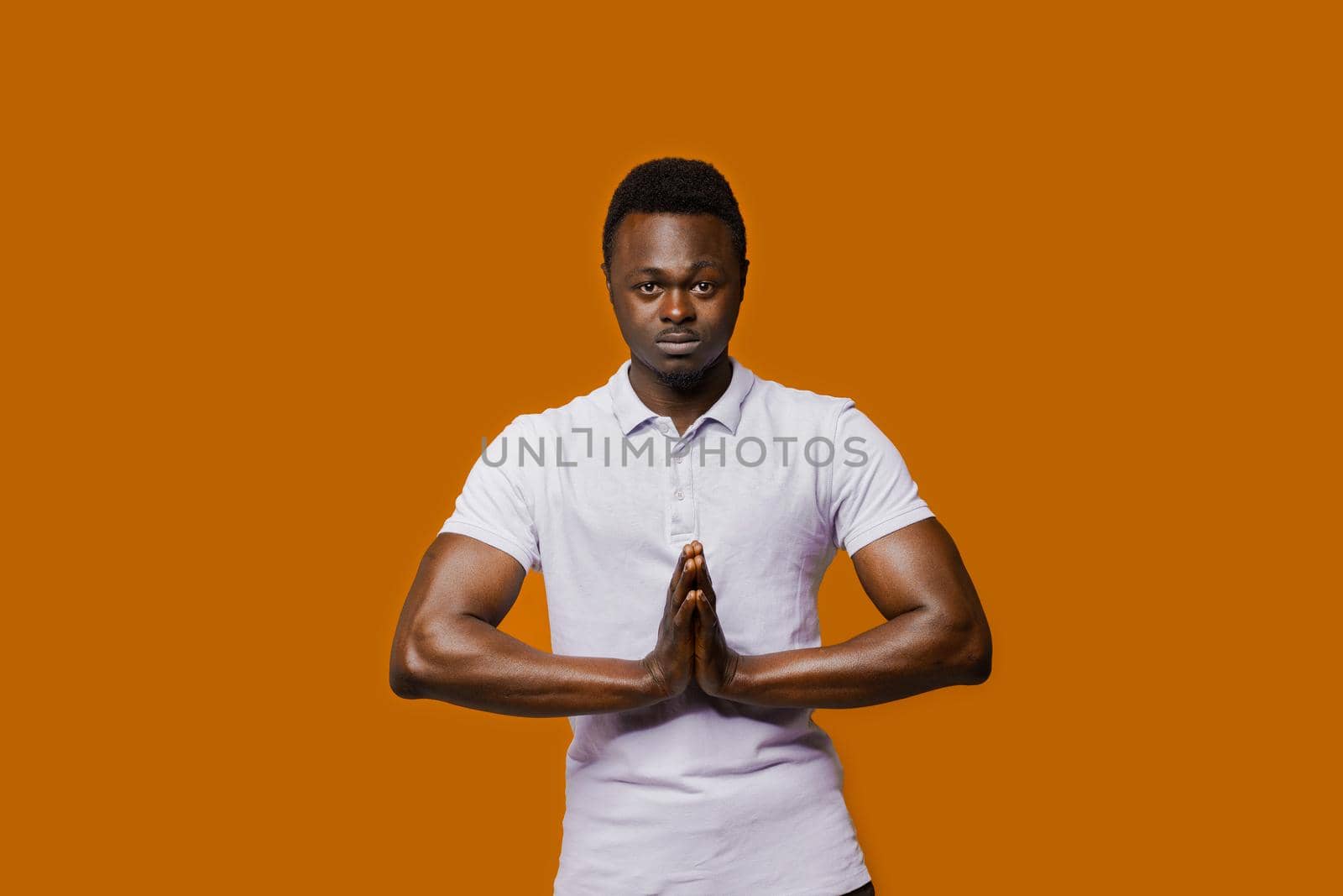 Relaxed black man closes eyes and does yoga. Calm and pacification of a african man. Public influence on skin color. Tolerance to african nationality. by Rabizo