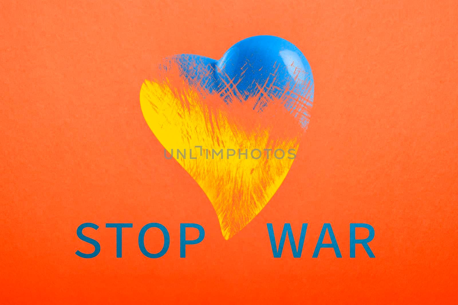 Stop war in Ukraine. Save Ukraine. The heart is painted in the colors of the Ukrainian flag - blue and yellow. No war text, poster on red background by SERSOL