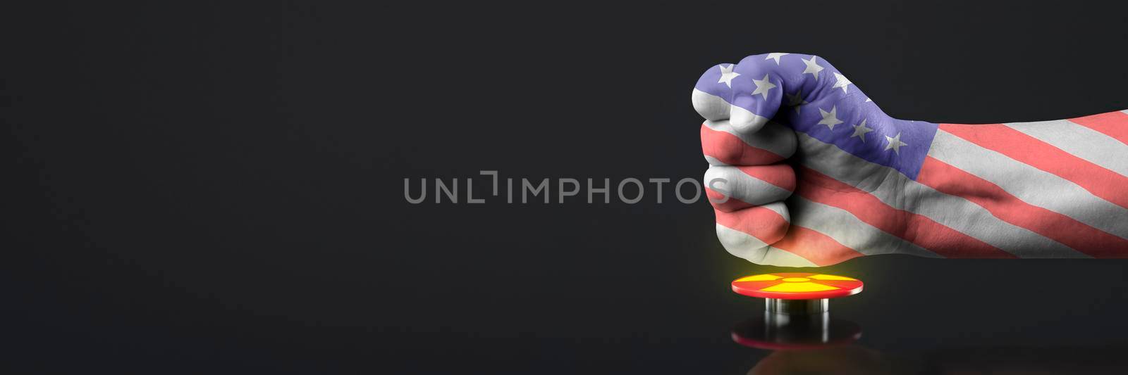 The hand presses the big red button. The concept of the threat of nuclear war. A hand painted in the colors of the American flag presses the button to launch a nuclear bomb