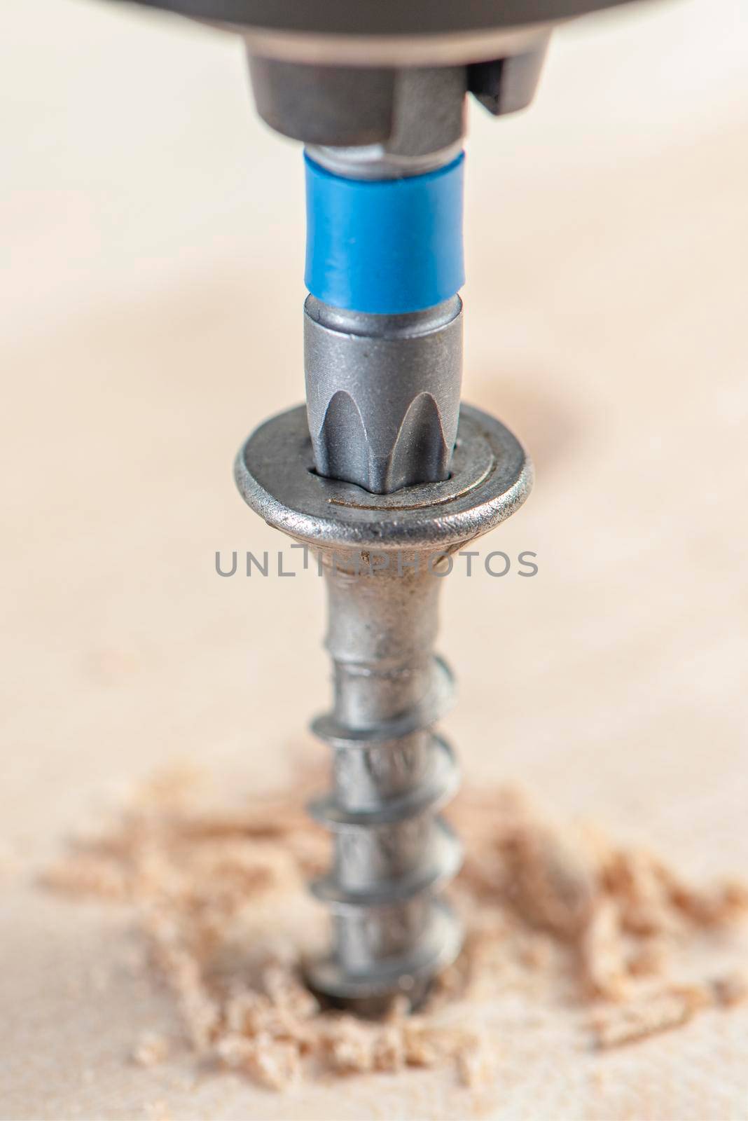 Manufacture of wooden furniture. Driving a screw into a piece of furniture. Assembling wooden furniture close-up.