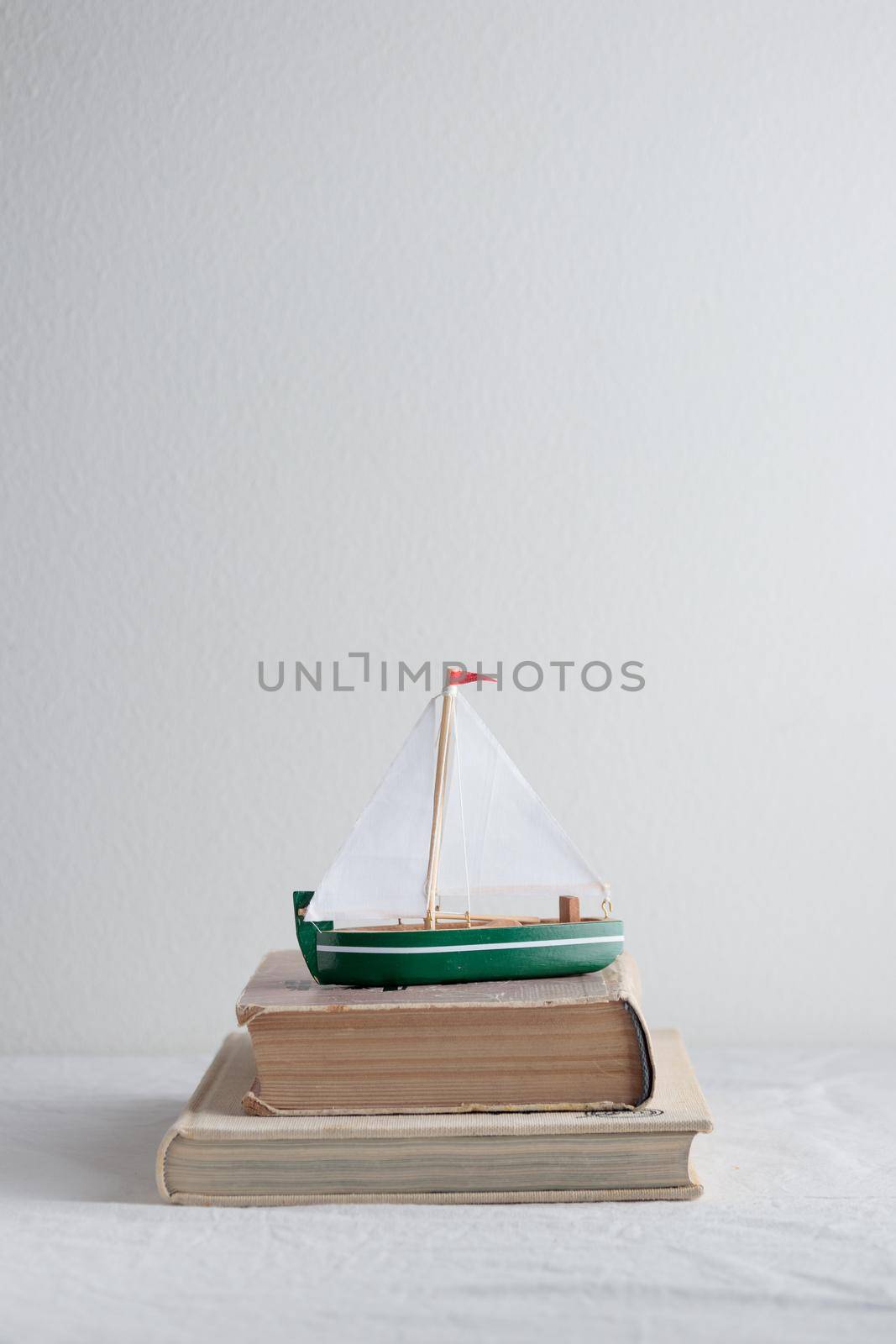 Boat model with old books on the table