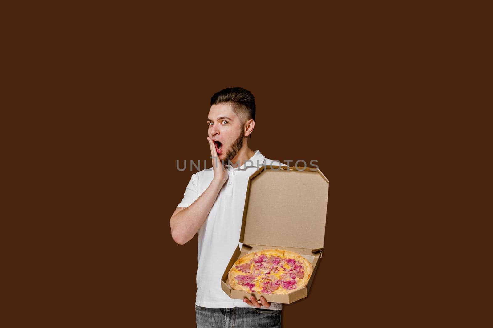Online pizza safety delivery servise from restaurant. Young surprised courier man open his mouth wide. Pizza with cheese boards advertise.