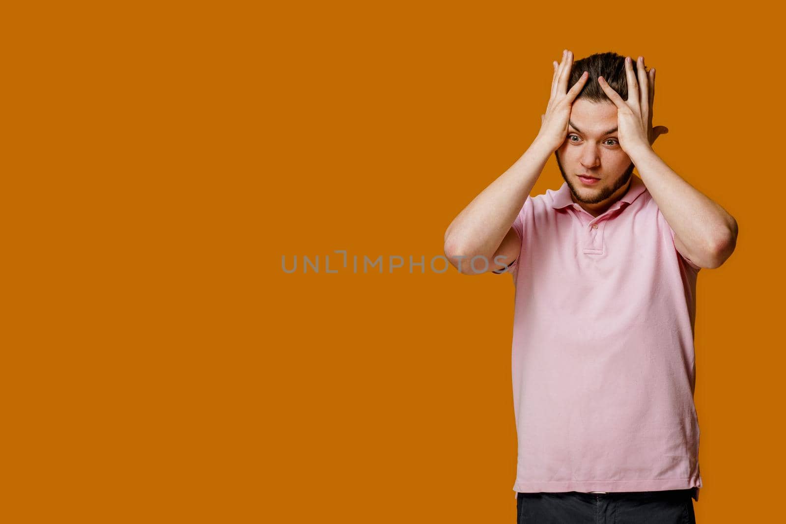 Medicine from headache of young bearded man. Student touches his head because he has a headache. Empty left side for text of advert