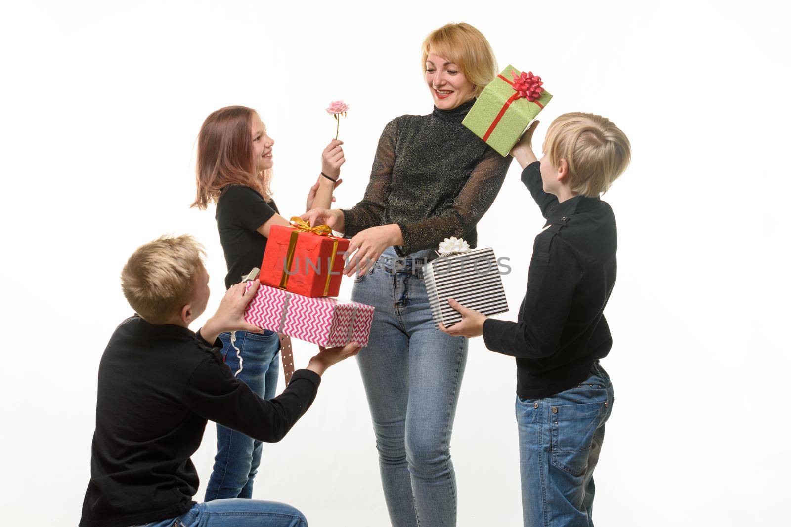 Children give a gift to mom, boys give a gift in boxes, flower girl