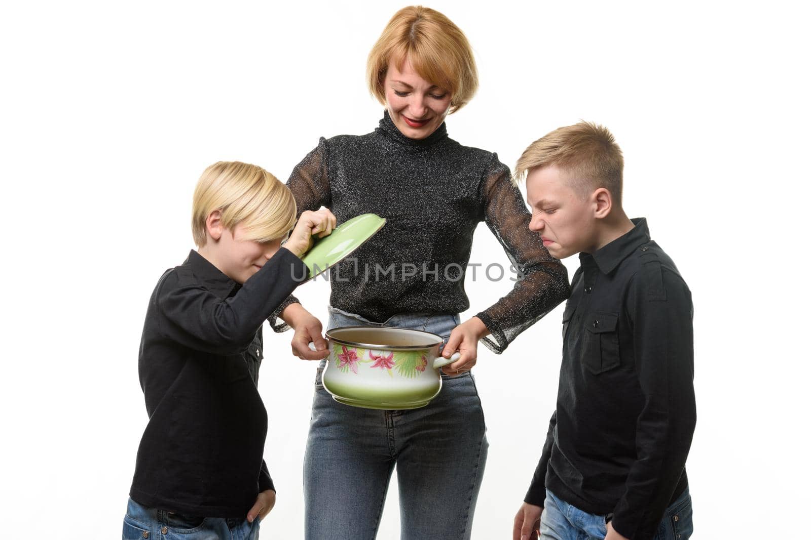 Mom cooked the soup, the children opened the pot and they did not like the food, isolated on a white background