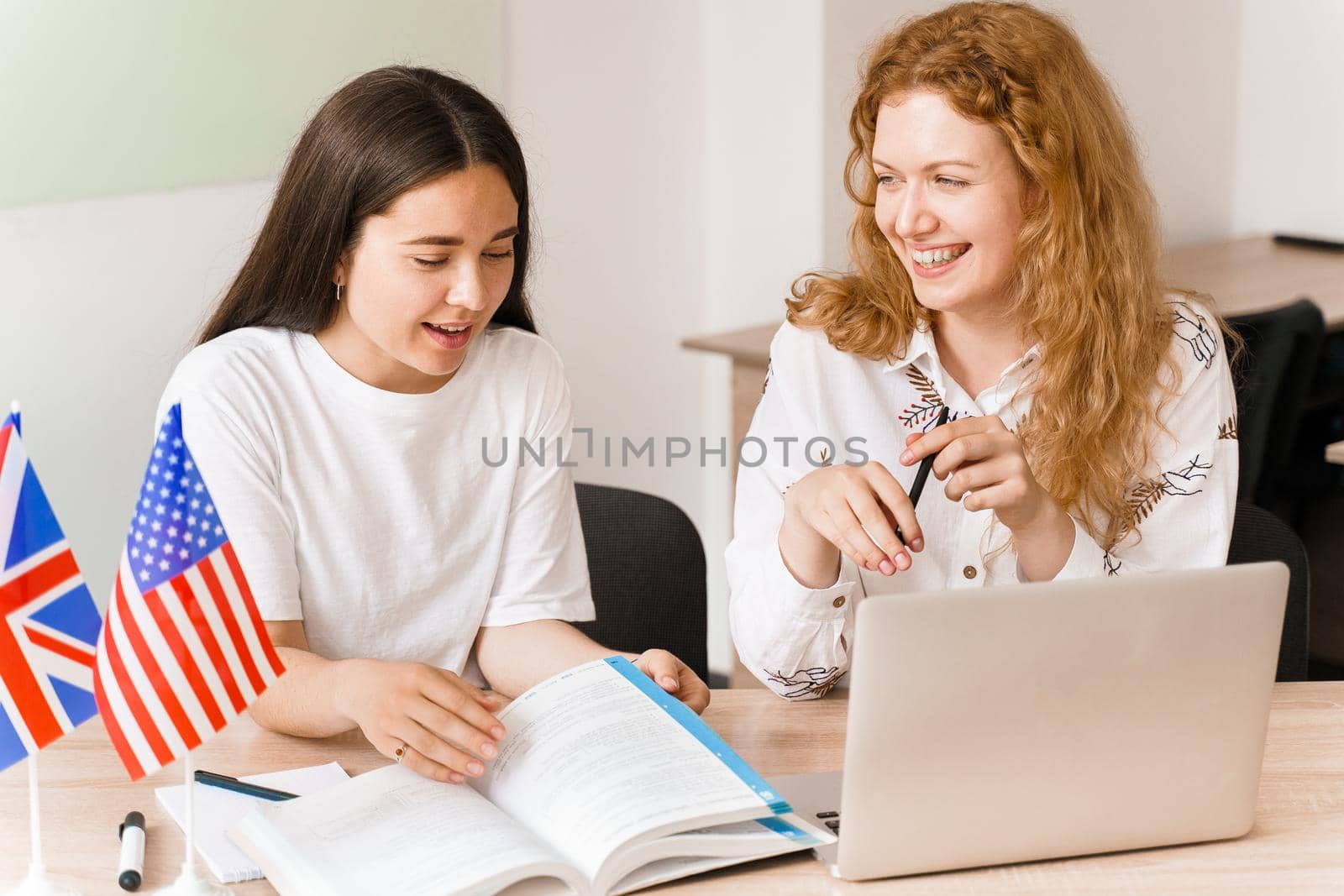 Foreign school private study, smile, laught with a school girl. Teacher explain grammar of native language using laptop. Prepearing to exam with tutor by Rabizo