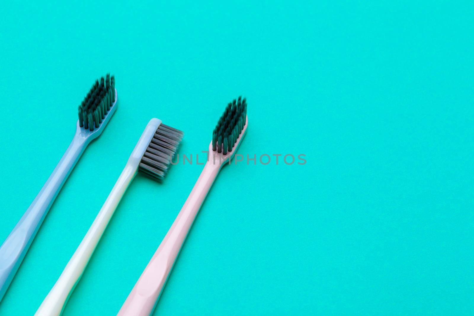 Flat lay composition with manual toothbrushes on color background, close up by Fabrikasimf