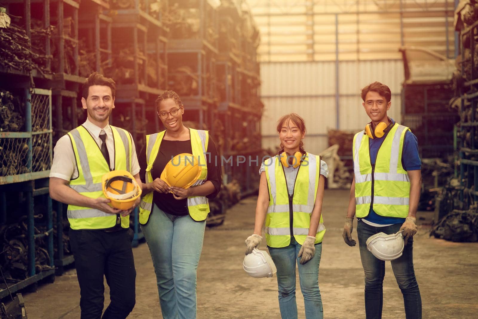 Group of Teamwork Worker mix race enjoy team working in heavy industry factory standing help together smiling happy