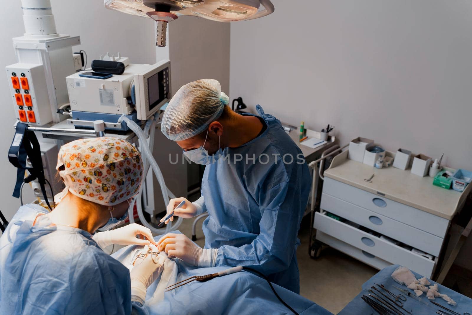 Blepharoplasty plastic surgery operation for modifying the eye region of the face in medical clinic. Surgeon makes an incision with a surgical knife