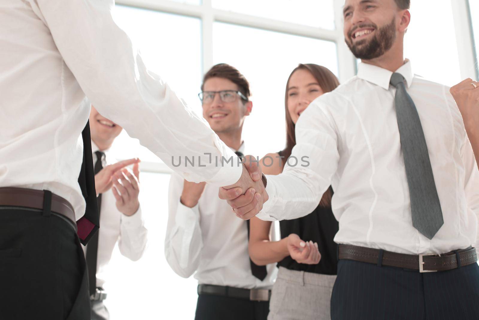 in the foreground.handshake business people in the office.business concept