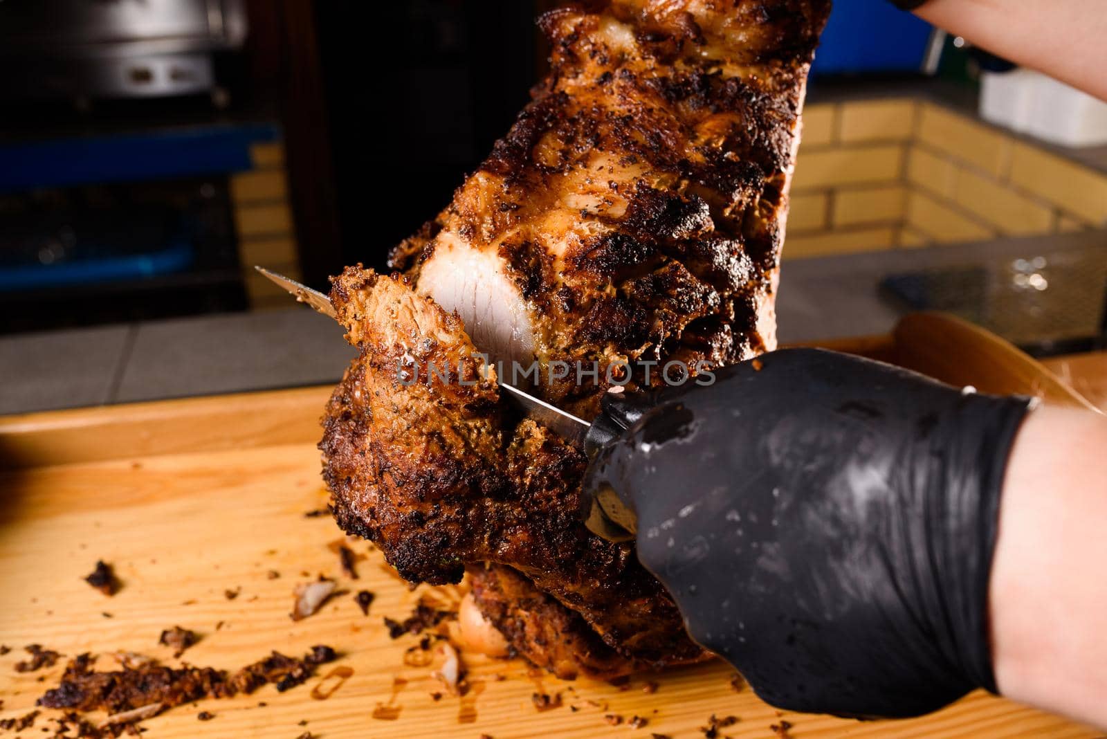 Fried pork cut with a knife. Big peace of pork meat. Cutting meat. Chef cut pork with knife. Advert for meat menu for restaurant