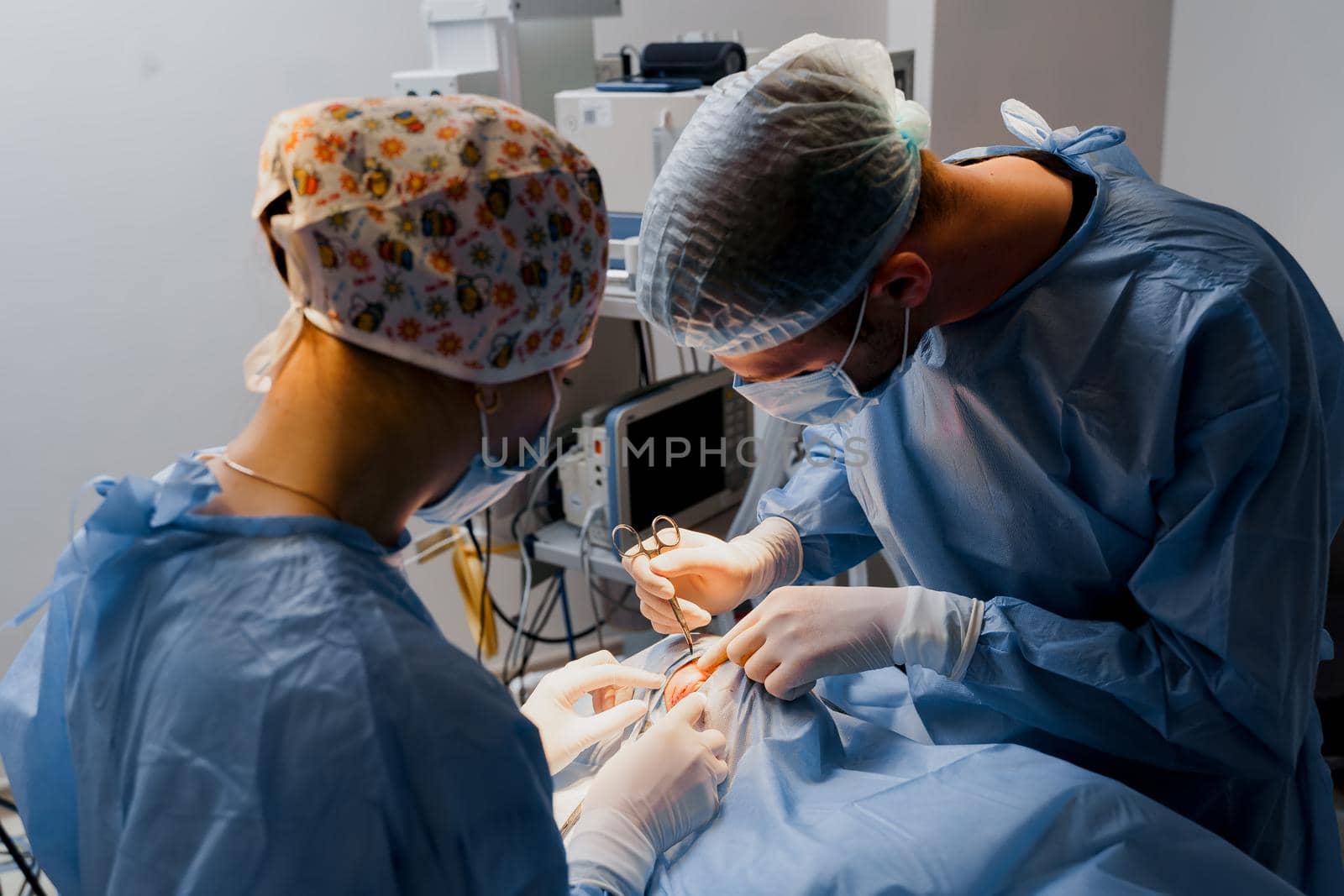 Blepharoplasty plastic surgery operation for modifying the eye region of the face in medical clinic. Surgeon makes an incision with a surgical knife. by Rabizo