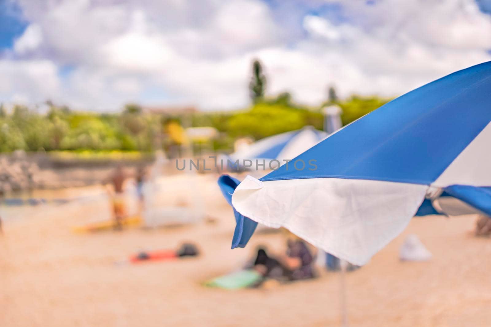 Beach umbrella on the sandy beach Naminoue in Naha City in Okinawa Prefecture, Japan. by kuremo