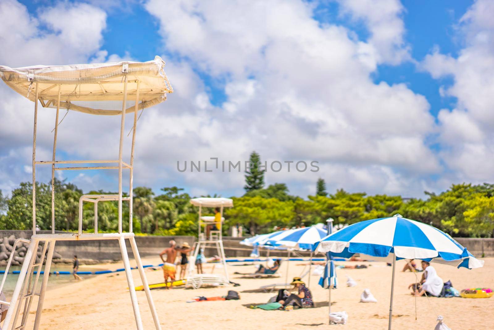 okinawa, japan - september 15 2019: Beach umbrellas and Lifeguard chairs on the sandy beach Naminoue in Naha City in Okinawa Prefecture, Japan.